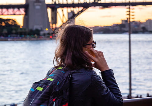 female-study-abroad-student-talking-on-a-cell-phone-in-sydney-harbour-australia.jpg