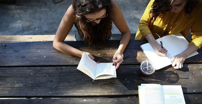 students studying at a picnic table