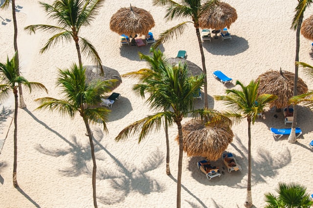 people lounging under umbrellas in aruba