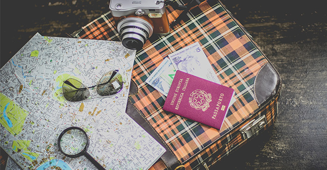 international travel documents, map, and camera on suitcase; international travel documents checklist