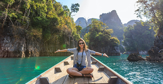 female-solo-traveler-sitting-on-a-boat-in-thailand