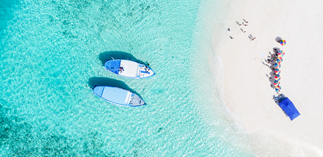 image of a beach with two small boats