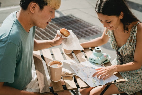 couple having breakfast while looking at a map