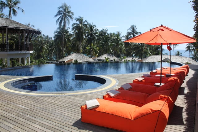 orange lounges near swimming pool