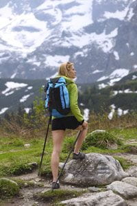 young woman backpacking in the mountains