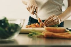 woman chopping carrots