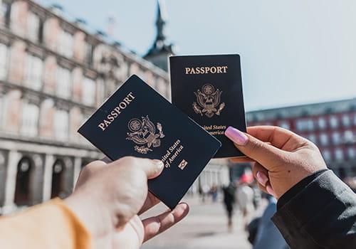 couple-holding-up-their-us-passports-in-madrid-spain.jpg