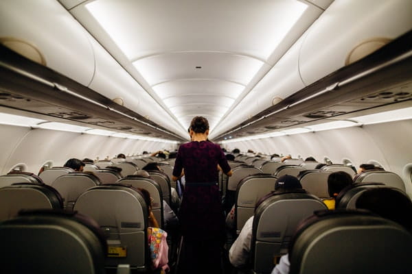 airline hostess walking through airplane