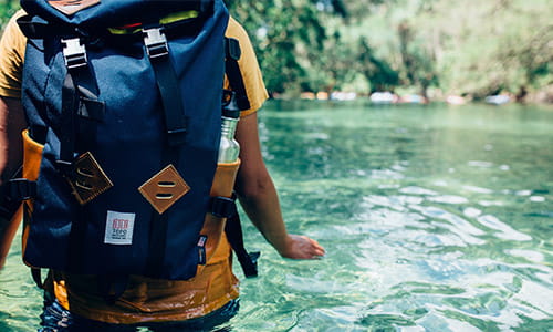 backpacker-wading-through-a-river-with-his-pack.jpg