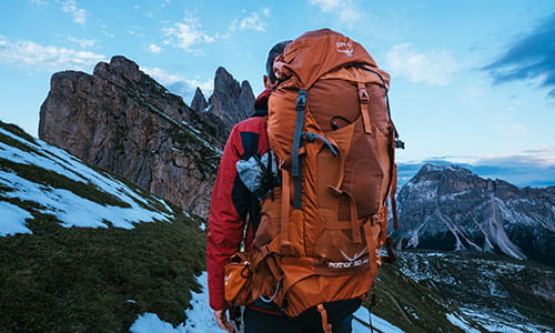 man-carrying-a-backpack-standing-on-a-mountain-in-italy.jpg