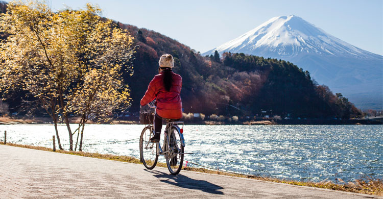 woman-riding-bike-near-mount-fuji-japan