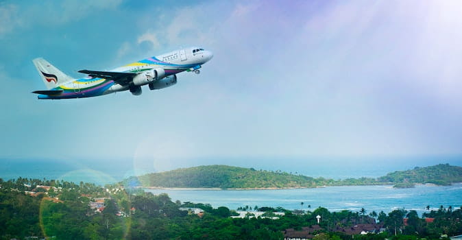 carbon offsetting flights featured image, airplane taking off over ocean