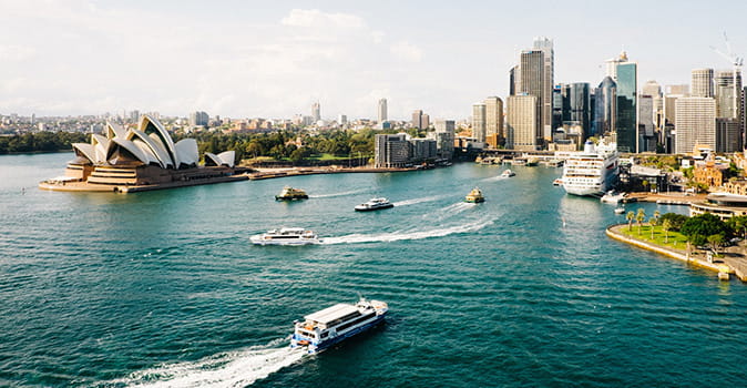 cruise travel insurance Australia featured image of boats in Sydney harbor