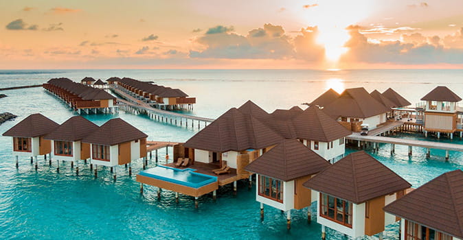 luxury summer vacation ideas featured image of over-the-water bungalows in maldives