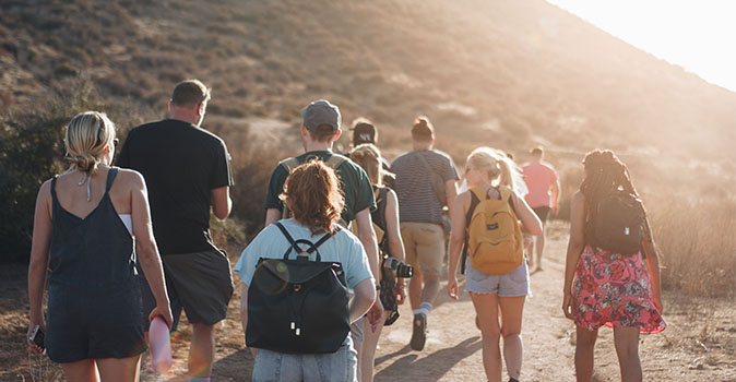 travelers hiking with group travel package