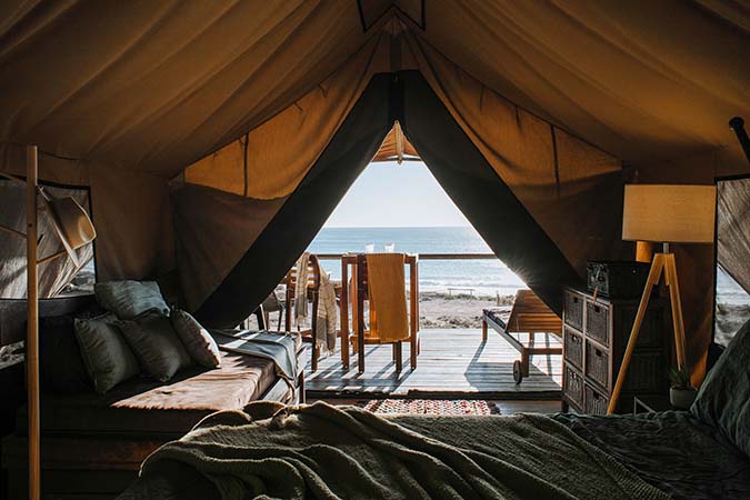 view-from-inside-tent-out-to-a-beach-what-is-travel-medical-insurance
