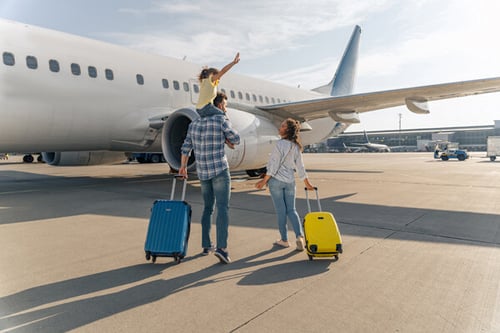 back-view-of-happy-family-standing-near-a-large-plane back-view-of-happy-family-standing-near-a-large-plane