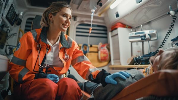 female-ems-professional-paramedic-comforting-injured-patient-on-the-way