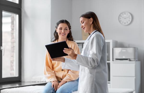 medicine--healthcare-and-people-concept---female-doctor-with-tablet