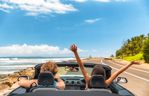 road-trip-car-holiday-happy-couple-driving-convertible-car-on