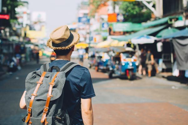 young-asian-traveling-backpacker-in-khaosan-road-outdoor-market-in