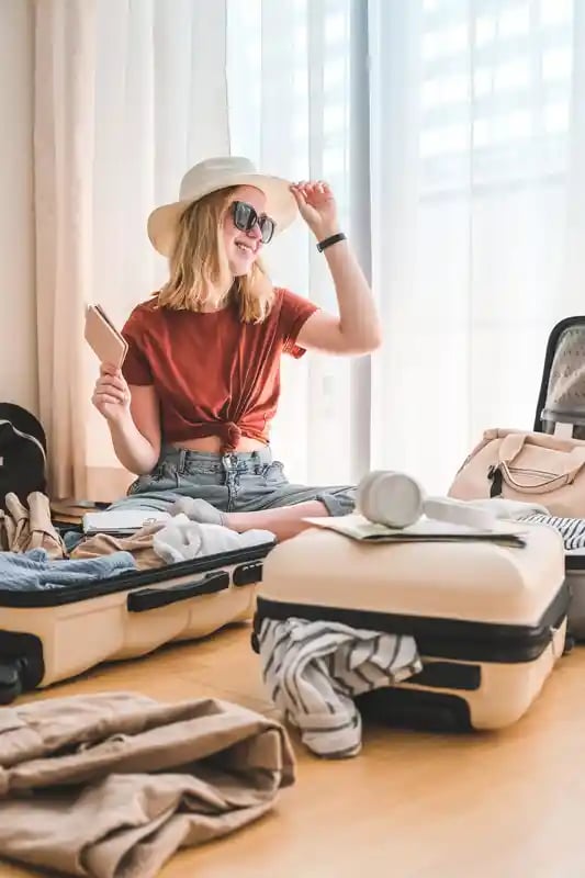 travel-staycation.local-travel-new-normal.girl-packing-luggage-in-suitcase