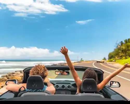 road-trip-car-holiday-happy-couple-driving-convertible-car-on