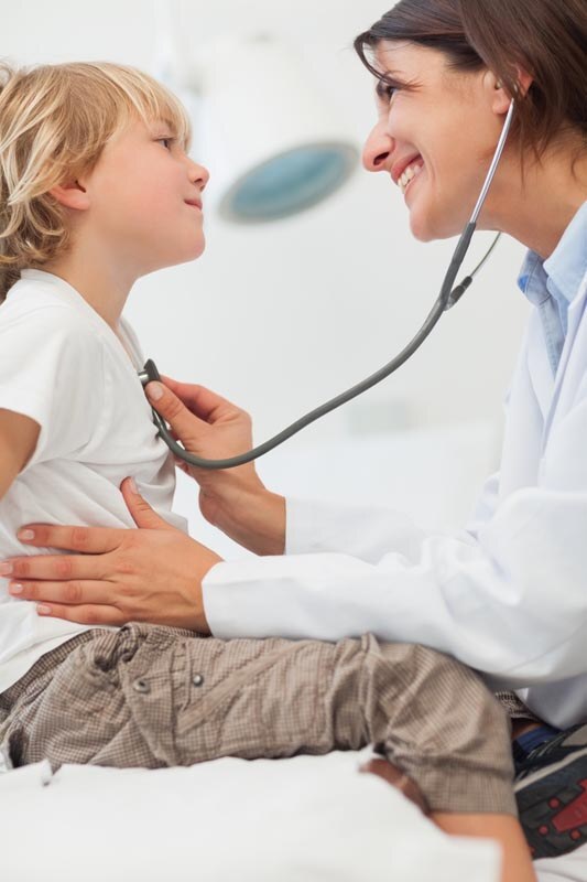 smiling-doctor-auscultating-a-child-with-a-stethoscope-in-examination